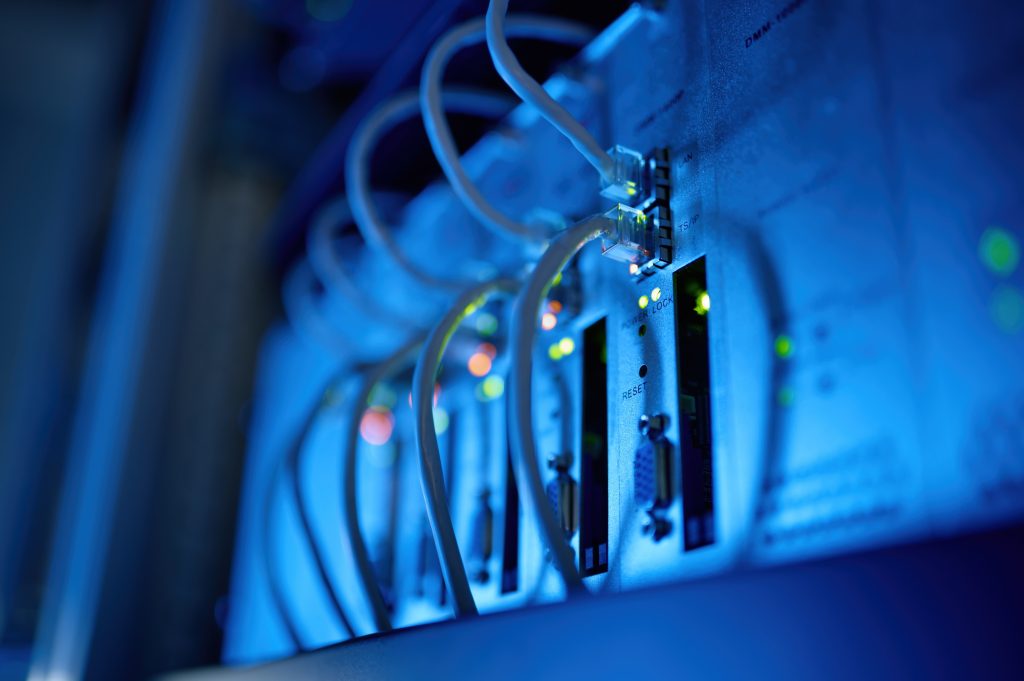 Closeup network server room with fiber optic hub.